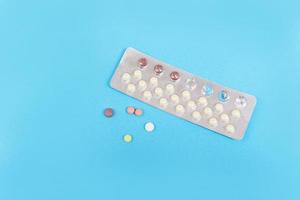Contraception pills on blue background Birth control contraceptive means prevent pregnancy photo
