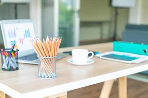 pencil in pencil holder on working table photo