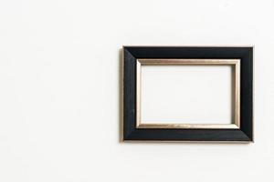 empty picture frame on white wall background photo