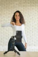 Latin woman created her dancing video by smartphone camera. To share video to social media application. photo