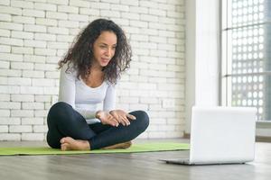 Latin woman teaching yoga online photo
