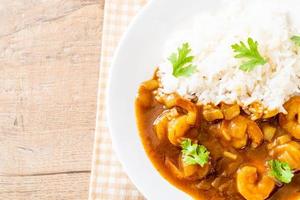 Shrimps in curry sauce on rice photo