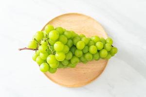 fresh green grape on wood plate photo