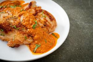 grilled chicken steak with red curry sauce photo