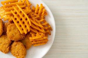 fried chicken nuggets with fried potatoes photo