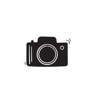 Photo camera vector icon with hand drawn doodle style isolated on white