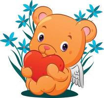 The cute cupid bear is sitting and holding the colored heart in the garden full of flowers vector