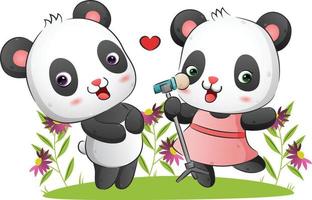 la feliz pareja de pandas canta y baila juntos en el jardín vector