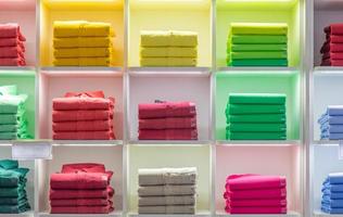 Polo t-shirt store interior. Shop shelves with  colored fashion cotton shirt photo