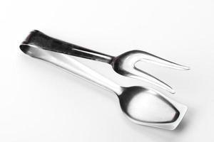 Beautiful steel tongs for serving isolated on a white background photo