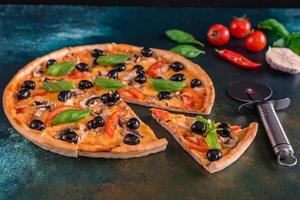 Delicious pizza with olives and chicken on wooden table photo