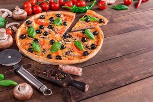 Delicious pizza with olives and chicken on wooden table