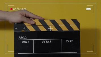 Clapper board. Close up hand and film making clapperboard isolated on background video