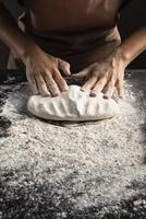chef kneading dough table photo