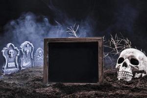 night graveyard with skull black sign photo
