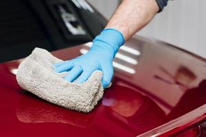 close up person cleaning car exterior photo