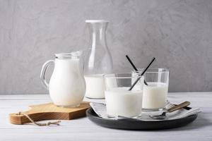 Various glass serving vessels with milk. Healthy and dietary food. photo