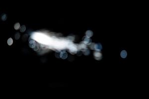 abstract light blue blur sparkler overlays elegant texture sparkling on black. photo