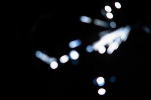 abstract light blue blur sparkler overlays elegant texture sparkling on black. photo