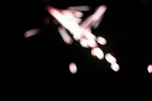 abstract red blur sparkler overlays elegant texture sparkling on black. photo