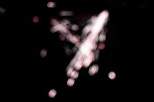 abstract red blur sparkler overlays elegant texture sparkling on black. photo