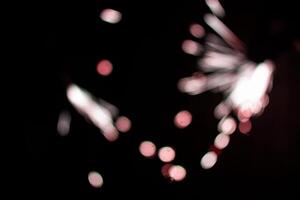 abstract red blur sparkler overlays elegant texture sparkling on black. photo