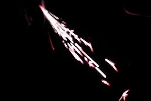 abstract lite red sparkler overlays elegant texture blur sparkling on black. photo