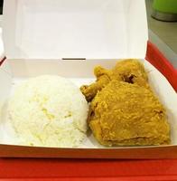 Fresh delicious crispy fried chicken golden brown with white rice on white box. photo