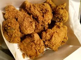 Fresh delicious crispy fried chicken golden brown on white box. photo