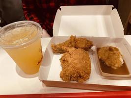 Fresh delicious crispy fried chicken golden brown with on white box. photo