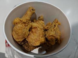 Fresh delicious crispy fried chicken golden brown on white box. photo