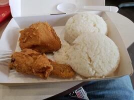 Fresh delicious crispy fried chicken golden brown with white rice on white box. photo