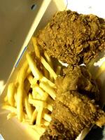 Fresh delicious crispy fried chicken golden brown with on white box. photo