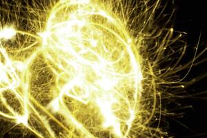 abstract line light yellow light trail glowing spiral stylish light effect on a black. photo