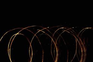 abstract circle gold light trail glowing spiral stylish light effect on a black. photo