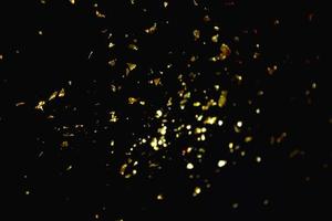 gold abstract pattern glitter stardust sparkling lights grunge on black. photo