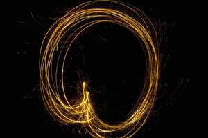 abstract circle gold light trail glowing spiral stylish light effect on a black. photo