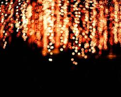 orange blur christmas lights background.abstract Lights unfocused blur light dots black . photo