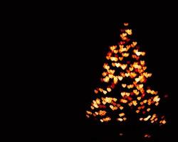 orange blur christmas lights background.abstract Lights unfocused blur light dots black . photo