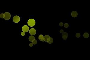 light green blur effect black background.abstract black unfocused blur light dots black . photo