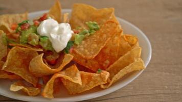 Mexican nachos tortilla chips with jalapeno, guacamole, tomatoes salsa and dip video