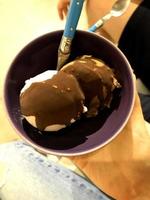 ice cream green flavor frozen dessert pattern in black cup hand holding on wood. photo