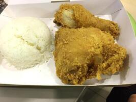 Fresh delicious crispy fried chicken golden brown with white rice on white box. photo