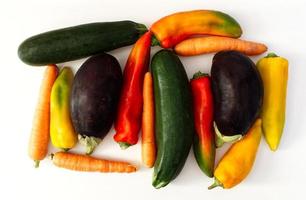 Mix of raw vegetables. Green Zucchini, Aubergine, Carrot, Pepper, isolated on white background. View from above photo