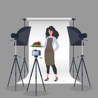 Culinary blogger. A woman in a kitchen apron holds a fried chicken on a tray. Camera on a tripod, softbox. The concept of a culinary blog or vlog. Vector.