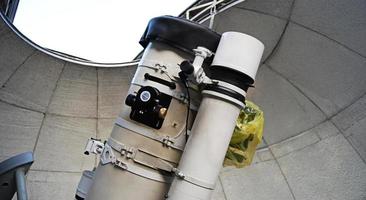 Powerful optical telescope under dome of an astronomic observatory photo