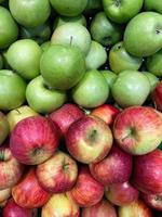 Fresh green and red apples on shelf. View from above photo