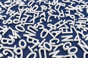 White letter and number are scattered chaotically on a table photo