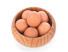 egg in a wooden bowl isolated on white background photo