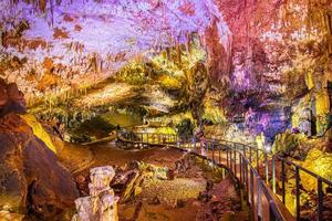 Pathway in Prometheus cave with beautiful colorful structures and formations photo